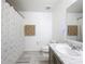 Modern bathroom featuring a marble countertop and a shower with a curtain at 2369 Crossandra St, Mascotte, FL 34753