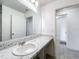 Well-lit bathroom showcasing a sink with a white basin and marbled countertop, creating a clean and modern aesthetic at 2369 Crossandra St, Mascotte, FL 34753