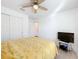 Bedroom featuring a bed, closet, and a ceiling fan at 2369 Crossandra St, Mascotte, FL 34753