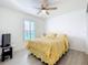 Bedroom with a bed, ceiling fan, and natural light from the window at 2369 Crossandra St, Mascotte, FL 34753