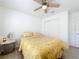 Bedroom featuring a bed, ceiling fan, and closet with sliding doors at 2369 Crossandra St, Mascotte, FL 34753