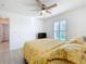Bedroom with a bed, ceiling fan, and window with shutters at 2369 Crossandra St, Mascotte, FL 34753