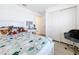 Bright bedroom with a bed, desk, and ample closet space at 2369 Crossandra St, Mascotte, FL 34753