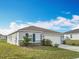 Inviting single-story home with well-kept lawn, complemented by simple landscaping and a convenient two-car garage at 2369 Crossandra St, Mascotte, FL 34753