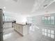 Open kitchen featuring a large island, modern appliances, and a view into the dining and living area at 2369 Crossandra St, Mascotte, FL 34753