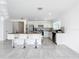 Modern kitchen with granite island and stainless steel appliances in an open floor plan at 2369 Crossandra St, Mascotte, FL 34753