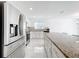 Bright kitchen boasts granite countertops, stainless steel appliances and white cabinets at 2369 Crossandra St, Mascotte, FL 34753