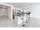 Modern kitchen features a granite island with seating and stainless steel appliances at 2369 Crossandra St, Mascotte, FL 34753