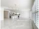 Bright living room with elegant chandeliers, fireplace, and access to the kitchen at 2369 Crossandra St, Mascotte, FL 34753