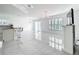 Bright living room with elegant chandeliers, fireplace, and access to the kitchen at 2369 Crossandra St, Mascotte, FL 34753