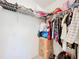 Organized walk-in closet with metal shelving, hanging racks, and storage boxes, maximizing space and functionality at 2369 Crossandra St, Mascotte, FL 34753