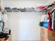 Walk-in closet with ample storage space on the shelves and hanging racks, perfect for organizing clothes and accessories at 2369 Crossandra St, Mascotte, FL 34753