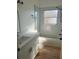 Updated bathroom featuring double vanity, bathtub and modern fixtures at 2410 Shelby Cir, Kissimmee, FL 34743
