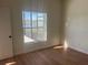 Cozy bedroom with wood-look flooring and a peaceful view of the lake at 2410 Shelby Cir, Kissimmee, FL 34743