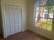 Neutral bedroom with wood-look floors and a closet with folding doors at 2410 Shelby Cir, Kissimmee, FL 34743