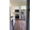 Bright kitchen featuring wood floors, stainless steel appliances and white cabinets at 2410 Shelby Cir, Kissimmee, FL 34743