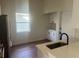 Bright kitchen featuring wood floors and stainless steel appliances at 2410 Shelby Cir, Kissimmee, FL 34743