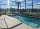 Backyard pool with screened enclosure and peaceful lake views at 2410 Shelby Cir, Kissimmee, FL 34743