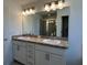 Double vanity in the bathroom with ample storage and modern lighting at 277 Harper Estates Cir, Lake Wales, FL 33859