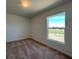 Bright bedroom featuring plush carpeting and a sun-filled window overlooking the community at 277 Harper Estates Cir, Lake Wales, FL 33859