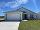 Charming single-story home with a two-car garage and well-manicured lawn at 277 Harper Estates Cir, Lake Wales, FL 33859