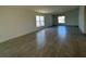 Open living room features tile flooring and plenty of natural light through large windows at 277 Harper Estates Cir, Lake Wales, FL 33859