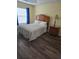 Bedroom with wood-toned furniture and gray bedding at 3362 Sebastion Ave, The Villages, FL 32163