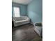 Cozy bedroom with light walls, comfy seating, and wood-look floors at 3362 Sebastion Ave, The Villages, FL 32163