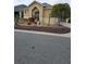 Tan house with nicely landscaped front yard at 3362 Sebastion Ave, The Villages, FL 32163