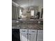 Kitchen features granite countertops and white cabinets at 3362 Sebastion Ave, The Villages, FL 32163
