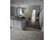 Open kitchen with granite countertops and view into the living room at 3362 Sebastion Ave, The Villages, FL 32163