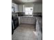 Bright kitchen with white cabinets, granite counters, and tile floors at 3362 Sebastion Ave, The Villages, FL 32163