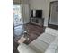 Living room features hardwood floors and a large TV at 3362 Sebastion Ave, The Villages, FL 32163