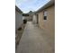 Long concrete patio with two chairs next to house at 3362 Sebastion Ave, The Villages, FL 32163