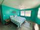 Bright bedroom with a king-size bed and light teal walls at 408 Hawthorne Blvd, Leesburg, FL 34748