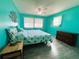 Spacious bedroom with king bed and teal walls at 408 Hawthorne Blvd, Leesburg, FL 34748