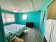 Bright bedroom with teal walls and a comfortable bed at 408 Hawthorne Blvd, Leesburg, FL 34748