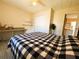 Spacious bedroom with a large bed and plenty of storage at 408 Hawthorne Blvd, Leesburg, FL 34748