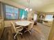 Cozy dining area with a round table, four chairs and a chandelier at 408 Hawthorne Blvd, Leesburg, FL 34748