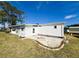 White mobile home with a patio and grassy yard at 408 Hawthorne Blvd, Leesburg, FL 34748