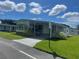 Front view of a manufactured home with a carport and speed limit sign at 408 Hawthorne Blvd, Leesburg, FL 34748