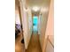 Long hallway with light wood flooring connecting rooms at 408 Hawthorne Blvd, Leesburg, FL 34748