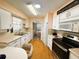 Open concept kitchen with white cabinets and stainless steel appliances at 408 Hawthorne Blvd, Leesburg, FL 34748