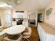 Eat-in kitchen with white cabinets, stainless steel appliances, and a breakfast bar at 408 Hawthorne Blvd, Leesburg, FL 34748