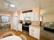 Stainless steel appliances and white cabinetry in open kitchen at 408 Hawthorne Blvd, Leesburg, FL 34748
