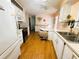 Clean kitchen, featuring white cabinets, stainless steel appliances, and wood floors at 408 Hawthorne Blvd, Leesburg, FL 34748