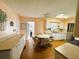 Eat-in kitchen with white cabinets, wood floors, and a table at 408 Hawthorne Blvd, Leesburg, FL 34748