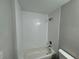 Bathroom with newly tiled walls, a shower/tub, and modern fixtures at 412 Avenue M Ne, Winter Haven, FL 33881