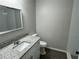Clean bathroom featuring granite counters, a large mirror, and new fixtures at 412 Avenue M Ne, Winter Haven, FL 33881