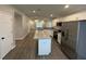 Open-concept kitchen with white cabinets, granite countertops, and stainless steel appliances at 412 Avenue M Ne, Winter Haven, FL 33881